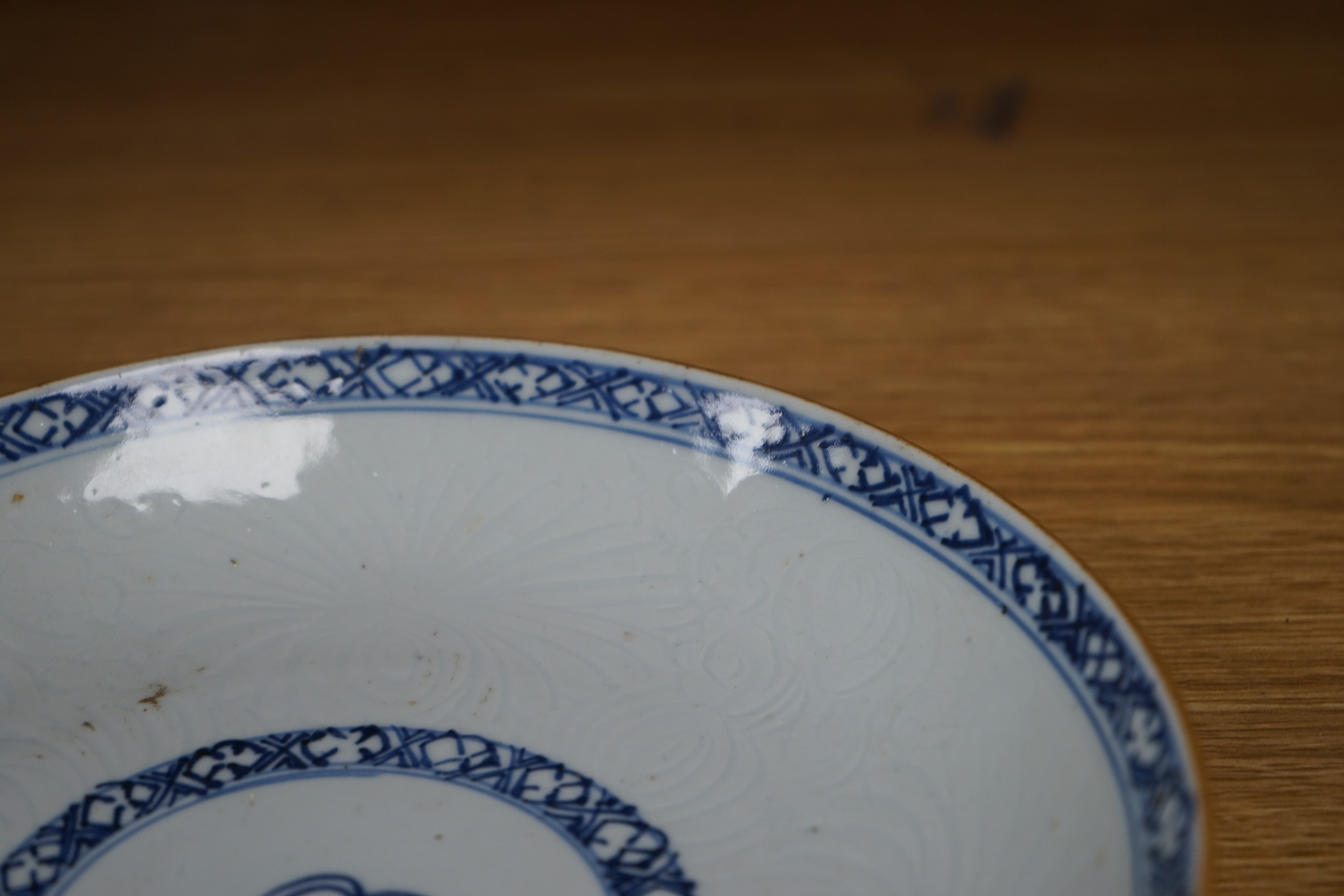 An 18th century Chinese shallow circular blue and white dish with incised decoration, Dia 22cm